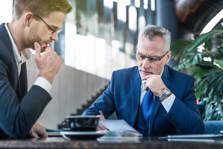 Two,Thoughtful,Business,Partners,Making,Notes,And,Discussing,Some,Project
